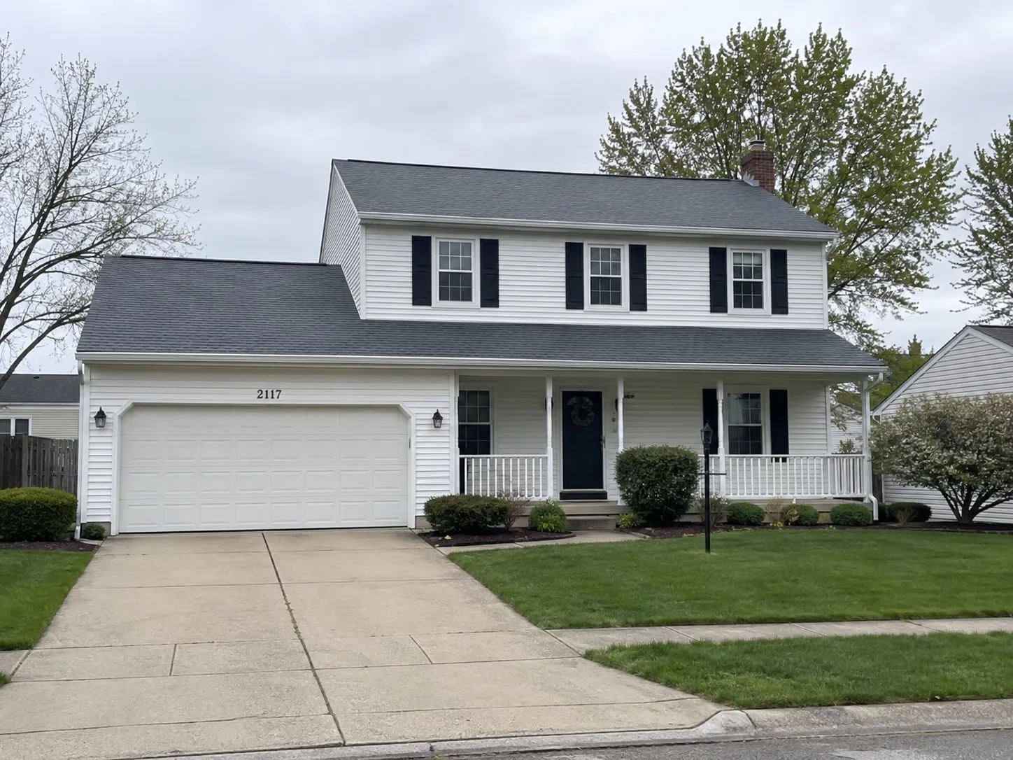 The same Ohio home after shingle restoration — clean bright roof, no algae