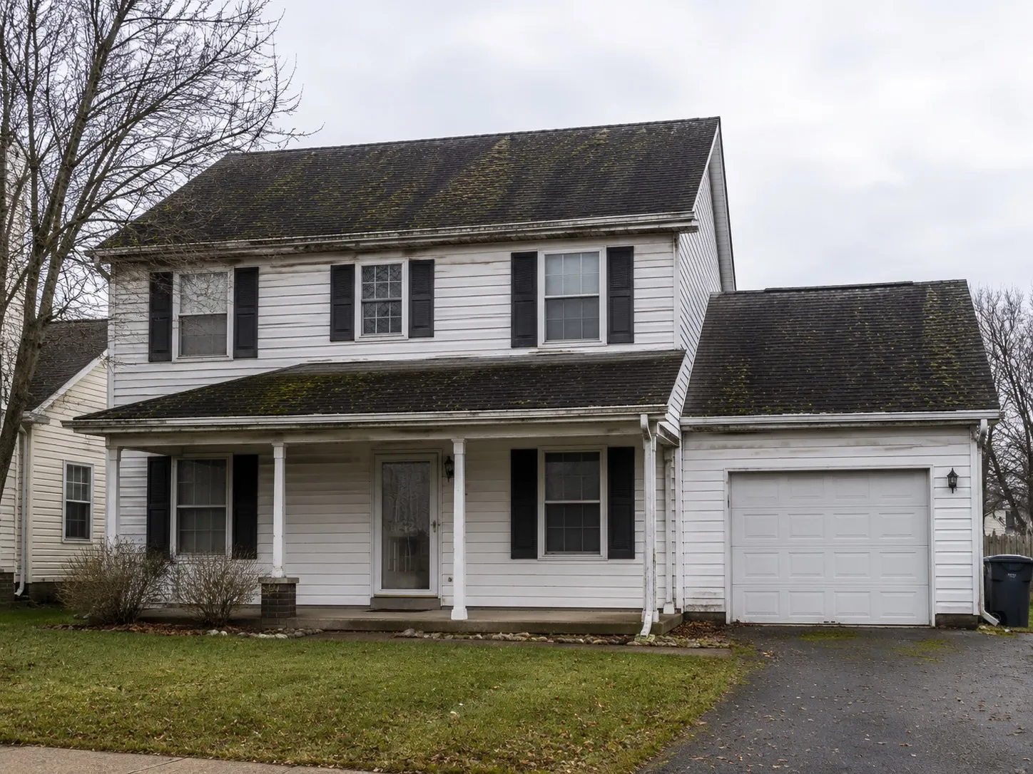 An Ohio home with a weathered algae-covered asphalt shingle roof before restoration
